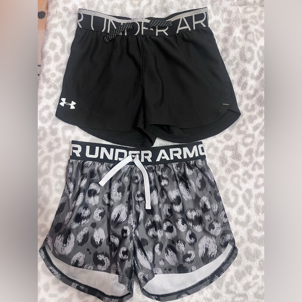 2 pairs of Under Armour shorts. Size youth medium.